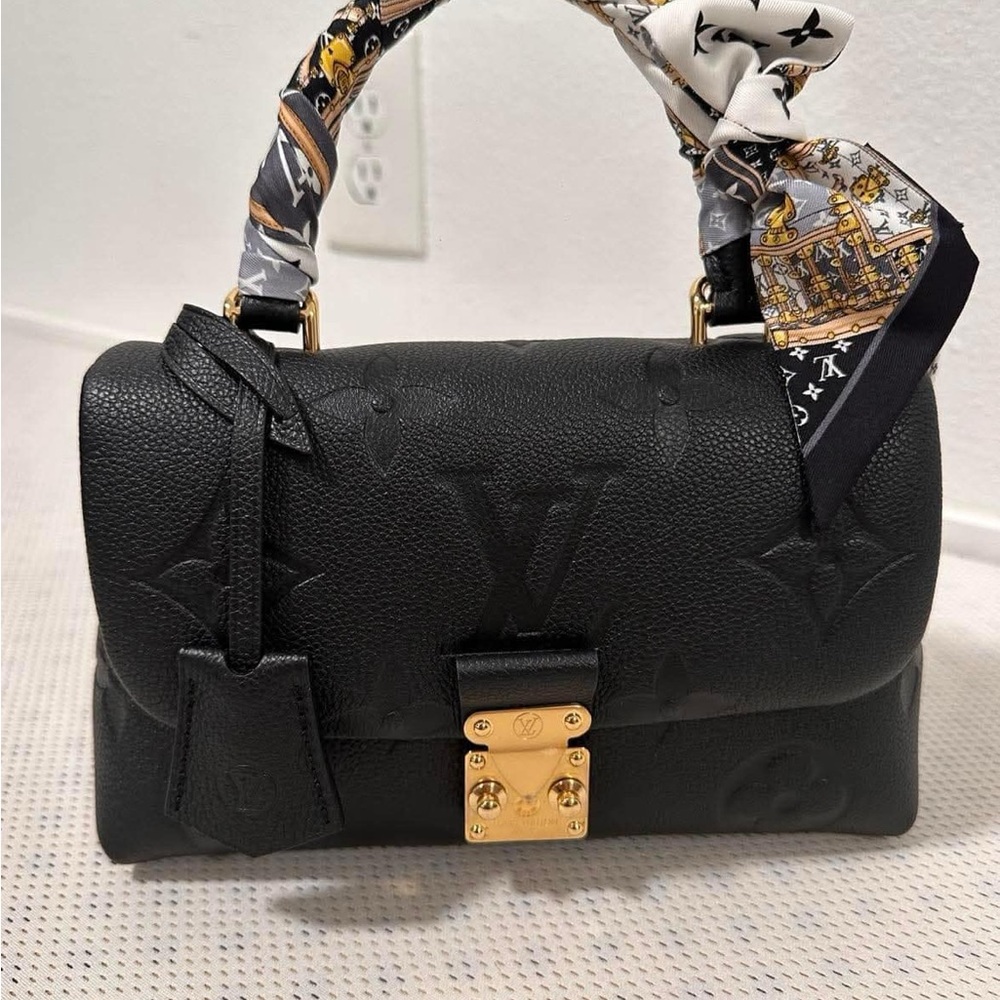 Stylish Black Shoulder Bag with Unique Handle and Gold Hardware